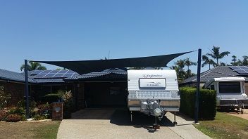 A large black custom made shade sail covering a customers caravan in East Brisbane