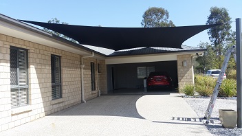 A black custom made shade sail over a carport for one of our clients located in South Brisbane